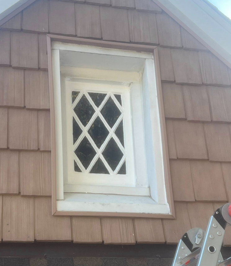 Diamond-pane window after — fresh white paint
