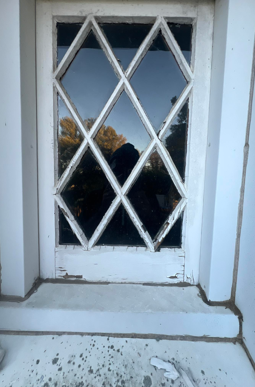 Diamond-pane window before — peeling paint